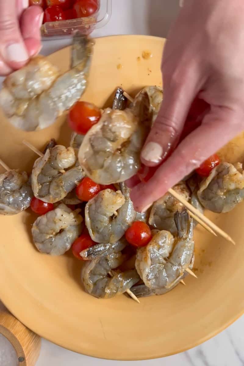 Add the shrimp to the marinade and toss until they are well coated. Allow the shrimp to marinate for about 15-20 minutes in the refrigerator. Preheat your grill or stovetop grill pan to medium-high heat. Thread the marinated shrimp and cherry tomatoes onto skewers, alternating between shrimp and tomatoes.