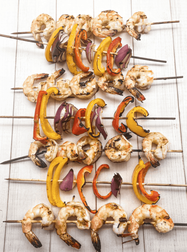 These are Grilled Shrimp and Vegetable Skewers with Salsa Verde that are drenched in salsa verde, cumin, and paprika. 