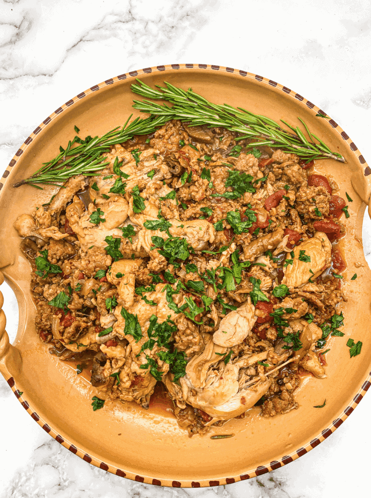 This Chicken and Sausage with Porcini Mushrooms is made with a whole chicken, sausage, porcini mushrooms, tomatoes, and simmered for 2 hours. 