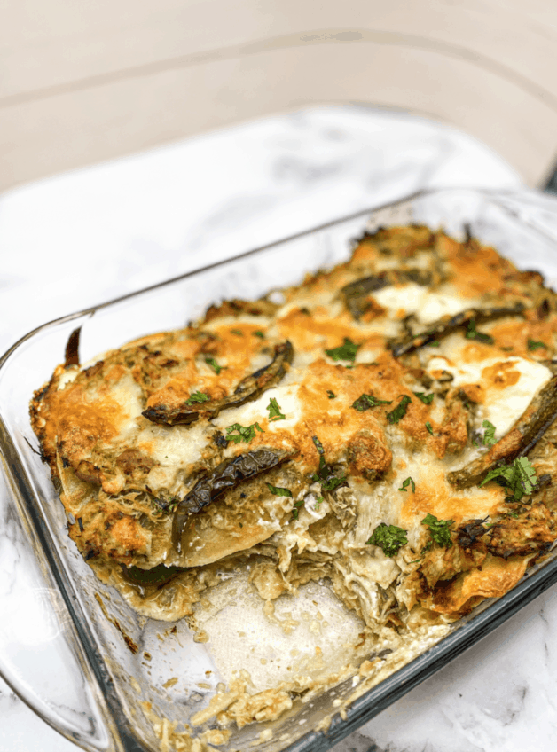 This Pastel Azteca is made with tortillas, salsa verde, carnitas, mozzarella and sour cream.