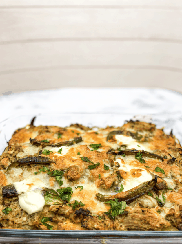 This Pastel Azteca is made with tortillas, salsa verde, carnitas, mozzarella and sour cream.