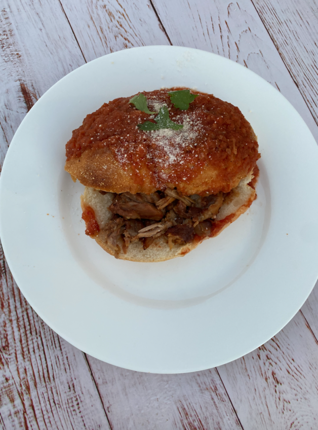 This Tortas Ahogadas dish is made with carnitas, refried beans, hot sauce, hard rolls and dipped in a tomato sauce. 