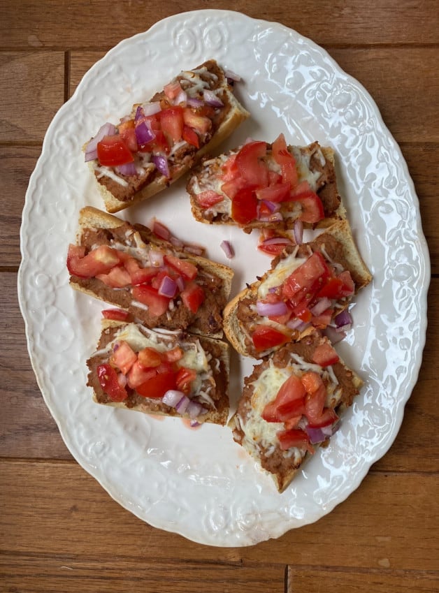 Molletes con Pico de Gallo is a traditional breakfast dish that incorporates refried beans, white melted cheese and pico de gallo. 