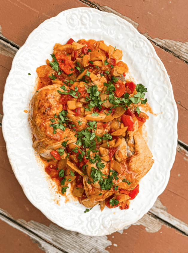 This Pollo Guisado Dominicano is made with onion, potatoes, bell peppers, sazon, tomatoes, spices and simmered for 2 hours. 