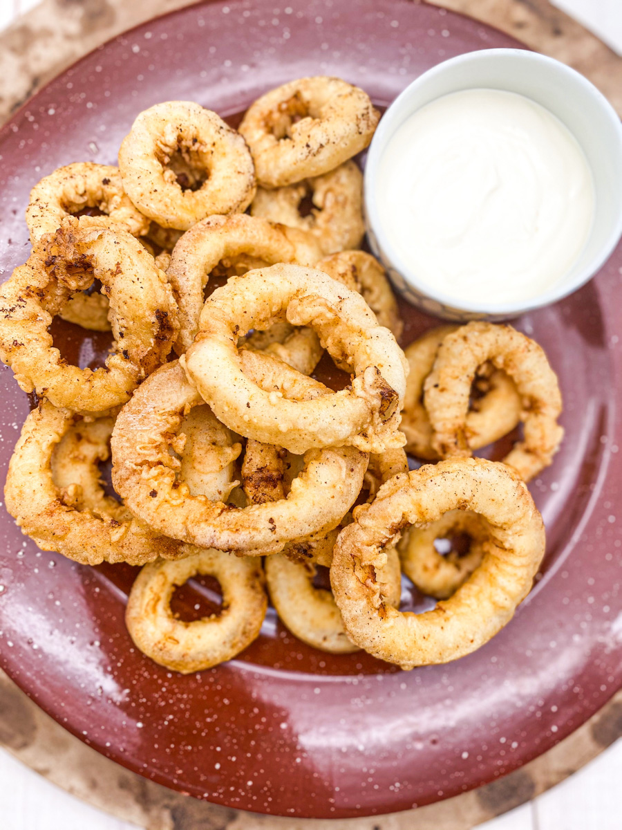This Fried Calamari Recipe with Lemon Aioli is made with buttermilk, flour, paprika, chili powder and fried to perfection.
