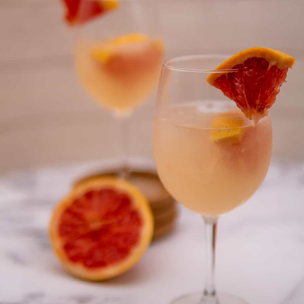 This Gin Grapefruit Cocktail is made with gin, grapefruit, seltzer water, and garnished with grapefruit slices.