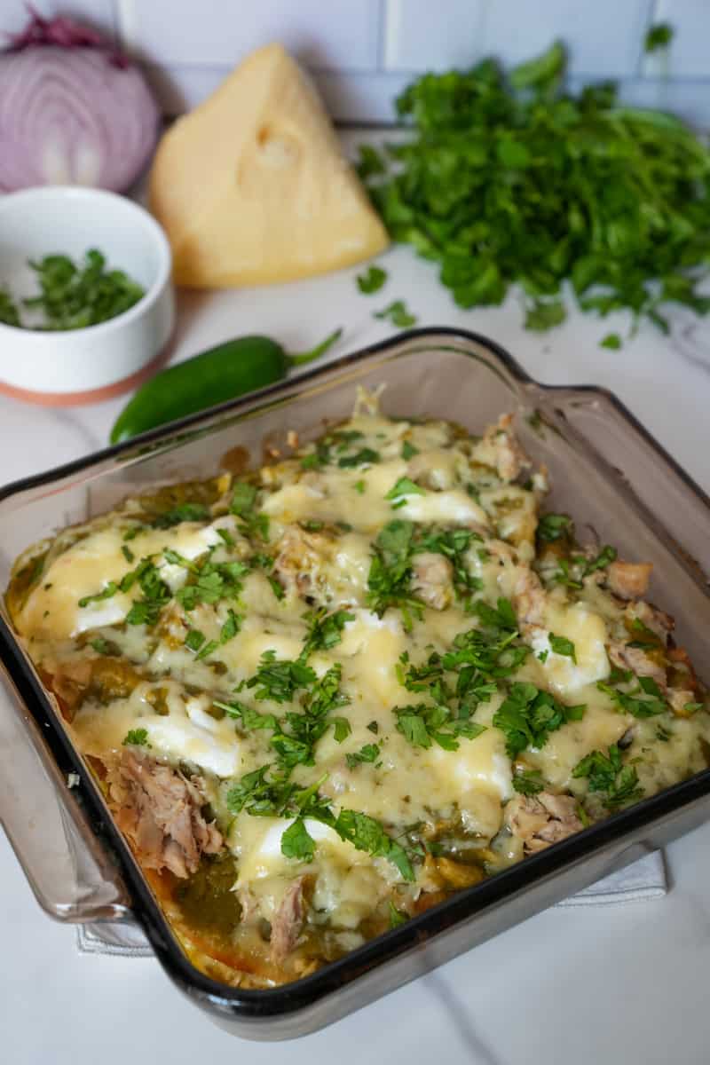 This Pastel Azteca Recipe is made with tortillas, salsa verde, carnitas, mozzarella and sour cream and assembled similarly to a lasagna.