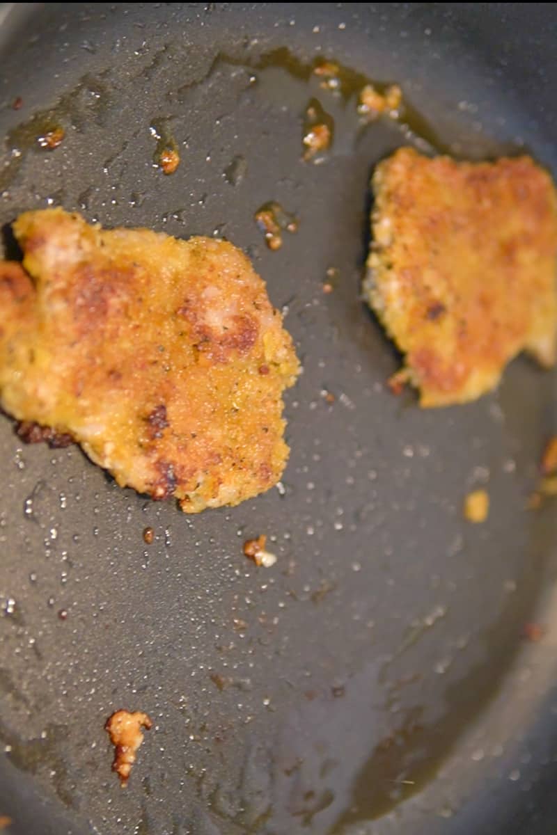 In a large skillet, add enough vegetable oil to cover the bottom by about ¼ inch. Heat the oil over medium-high heat until it reaches about 350°F (175°C). Carefully place the breaded pork chops into the hot oil, working in batches if necessary to avoid overcrowding the pan. Fry for about 3-4 minutes per side, or until golden brown and crispy. Adjust the heat if needed to maintain a steady temperature. Once the pork chops are cooked, transfer them to a plate lined with paper towels to drain any excess oil.