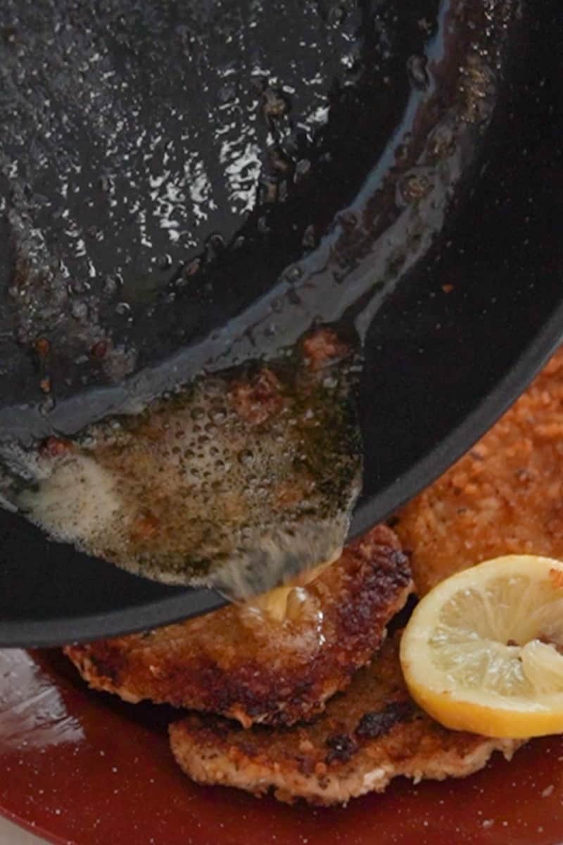 In a small saucepan, melt the butter over medium heat. Add the lemon slices and fresh thyme leaves. Cook for a couple of minutes until the butter is infused with the flavors of lemon and thyme. Place the fried pork chops on a serving platter and drizzle the lemon butter sauce over them. Garnish with additional fresh thyme leaves if desired.