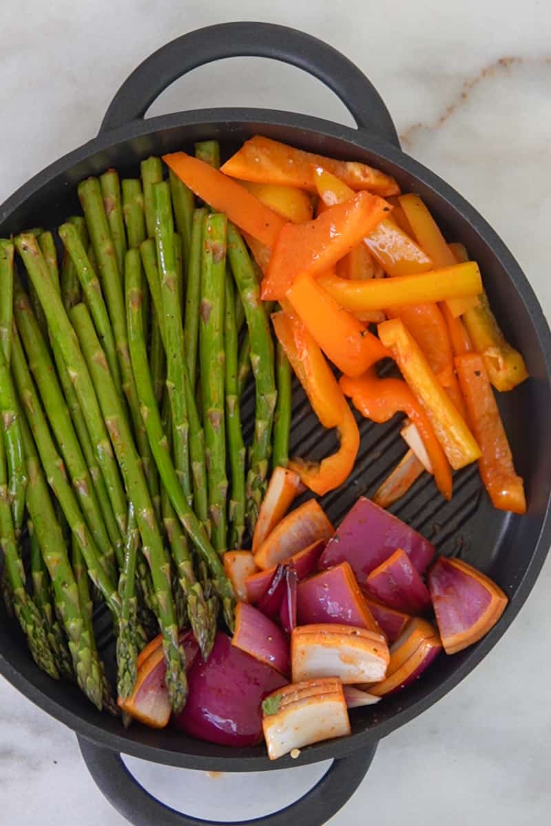 Grill the Vegetables: Carefully place the vegetables on the preheated grill pan, making sure they are in a single layer. Cook for about 6-8 minutes, flipping and rotating the vegetables occasionally to ensure even charring and cooking. The cooking time may vary depending on the thickness of the vegetables, so keep an eye on them. Remove from Heat and Garnish: Once the vegetables are tender and have developed a nice char, remove them from the grill pan and transfer to a serving platter. 