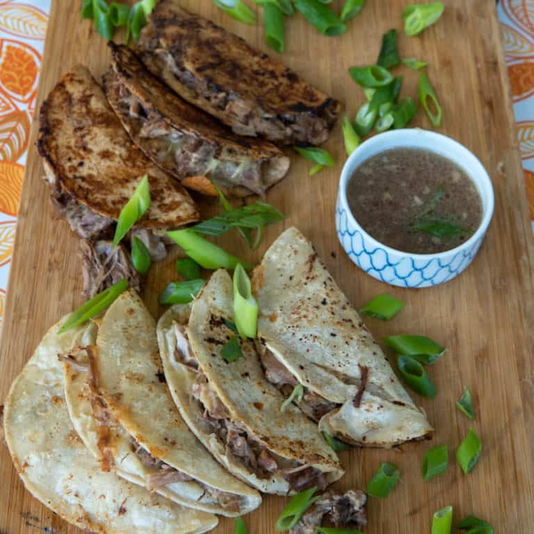 These Pork Birria Tacos are made with pork butt, vegetable umami, onion, garlic, mozzarella and corn tortillas.