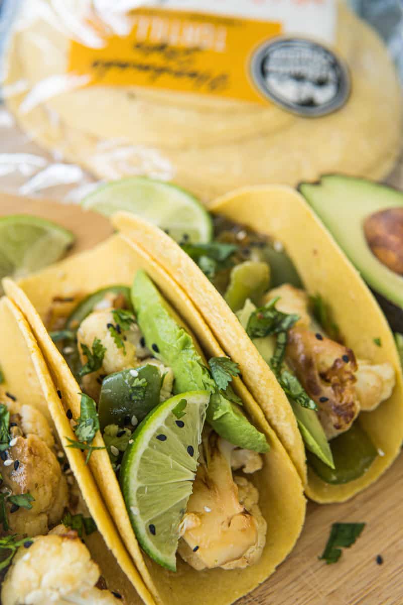 This Cauliflower Tacos Recipe are made with cauliflower, peppers, onion, soy sauce, sesame seeds, served on tortillas and garnished with cilantro and avocado slices.
