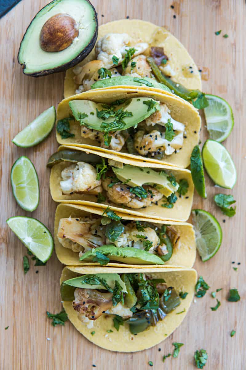 This Cauliflower Tacos Recipe are made with cauliflower, peppers, onion, soy sauce, sesame seeds, served on tortillas and garnished with cilantro and avocado slices.