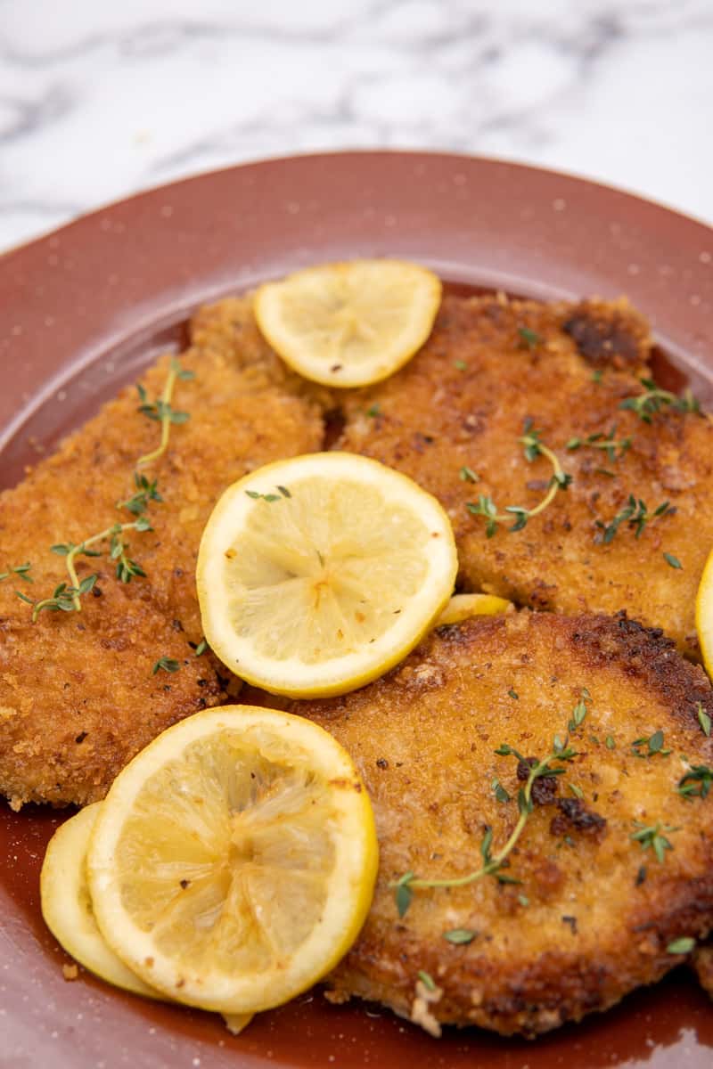 This Pork Schnitzel Recipe is made with pork chops, panko crumbs, garlic powder, onion powder, paprika, lemon and butter. It is absolutely phenomenal and family friendly. 