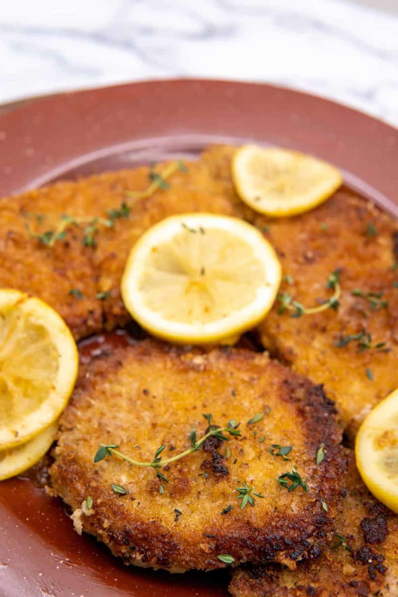 This Pork Schnitzel Recipe is made with pork chops, panko crumbs, garlic powder, onion powder, paprika, lemon and butter. It is absolutely phenomenal and family friendly. 