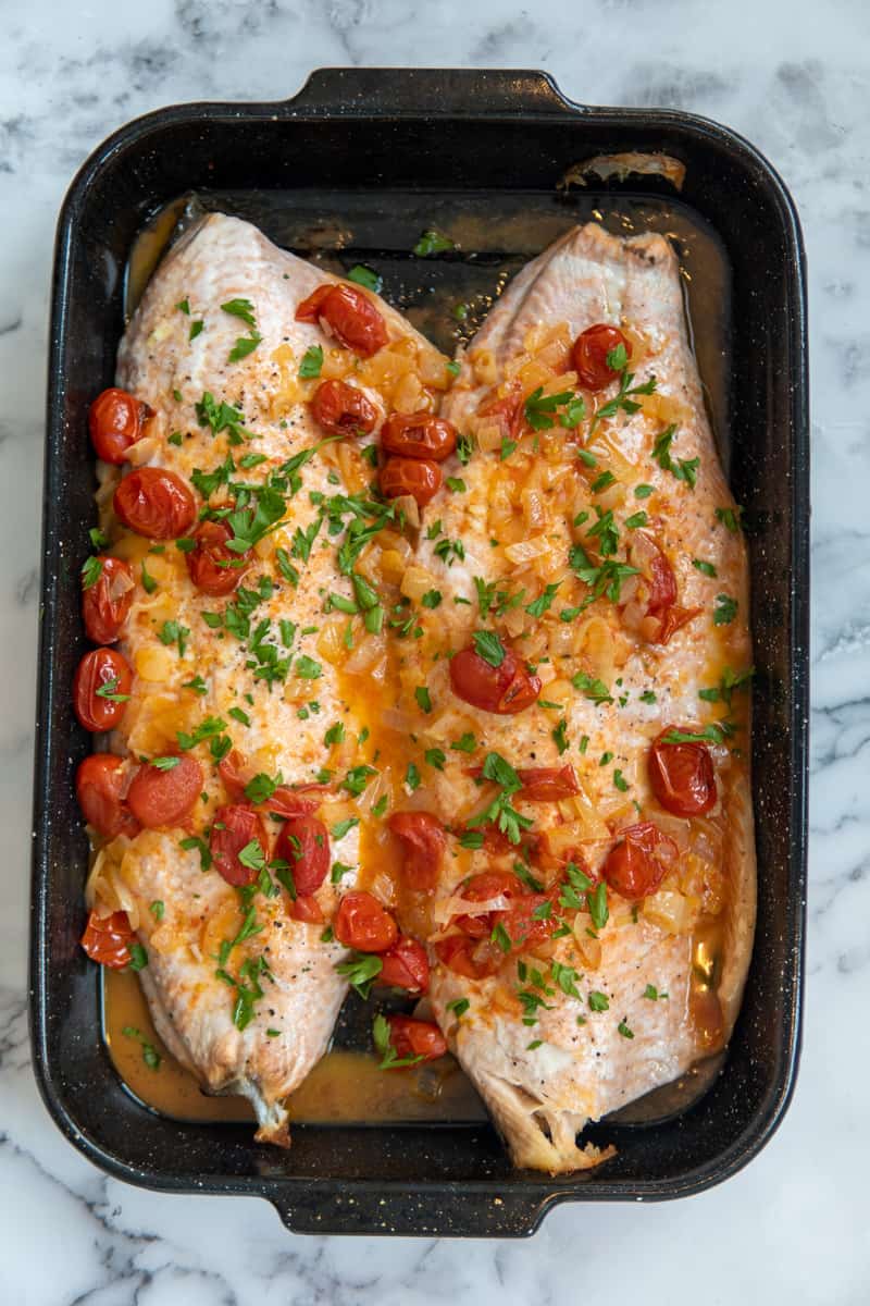 This White Wine Salmon Recipe is made with salmon, white wine, cherry tomatoes, onion, garlic and garnished with parsley.