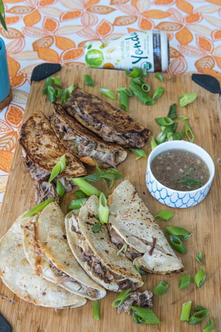 These Pork Birria Tacos dish has pork butt, vegetable umami, onion, garlic, mozzarella and corn tortillas.