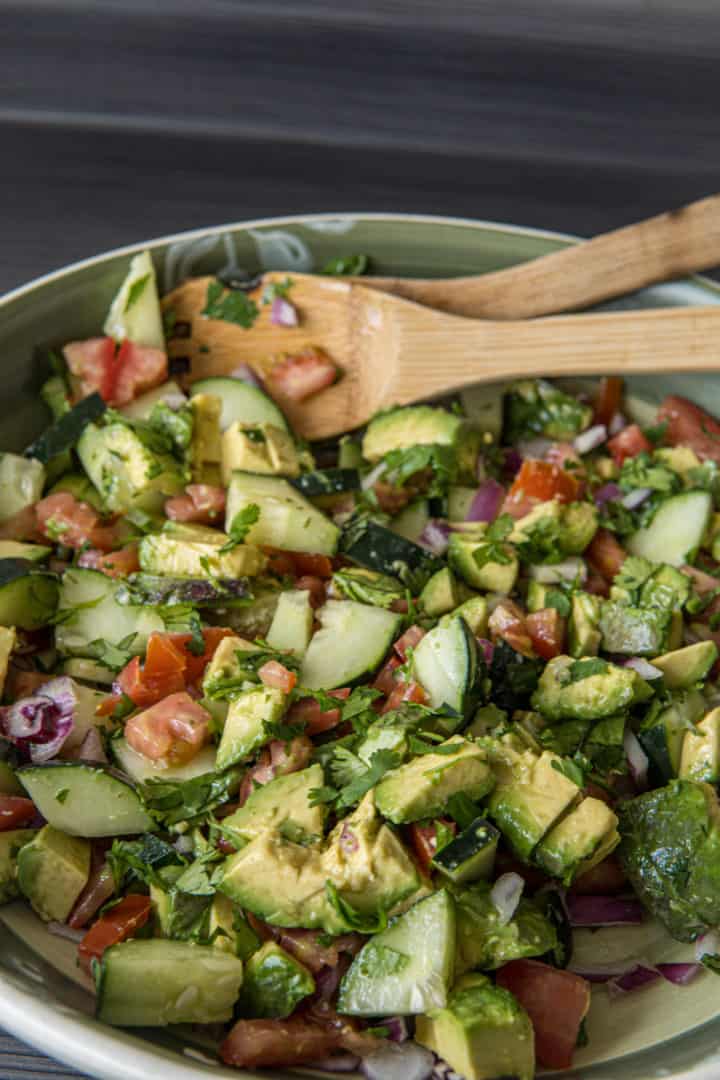 This Avocado Tomato Salad is made with tomatoes, cucumbers, avocados, onions, olive oil, lime juice, cilantro and salt.