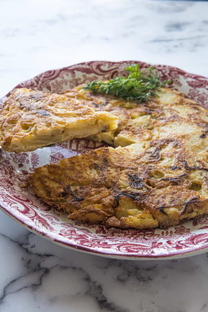 This is a simple tortilla de patata recipe made with gold potatoes, yellow onion, eggs, and lots of olive oil.