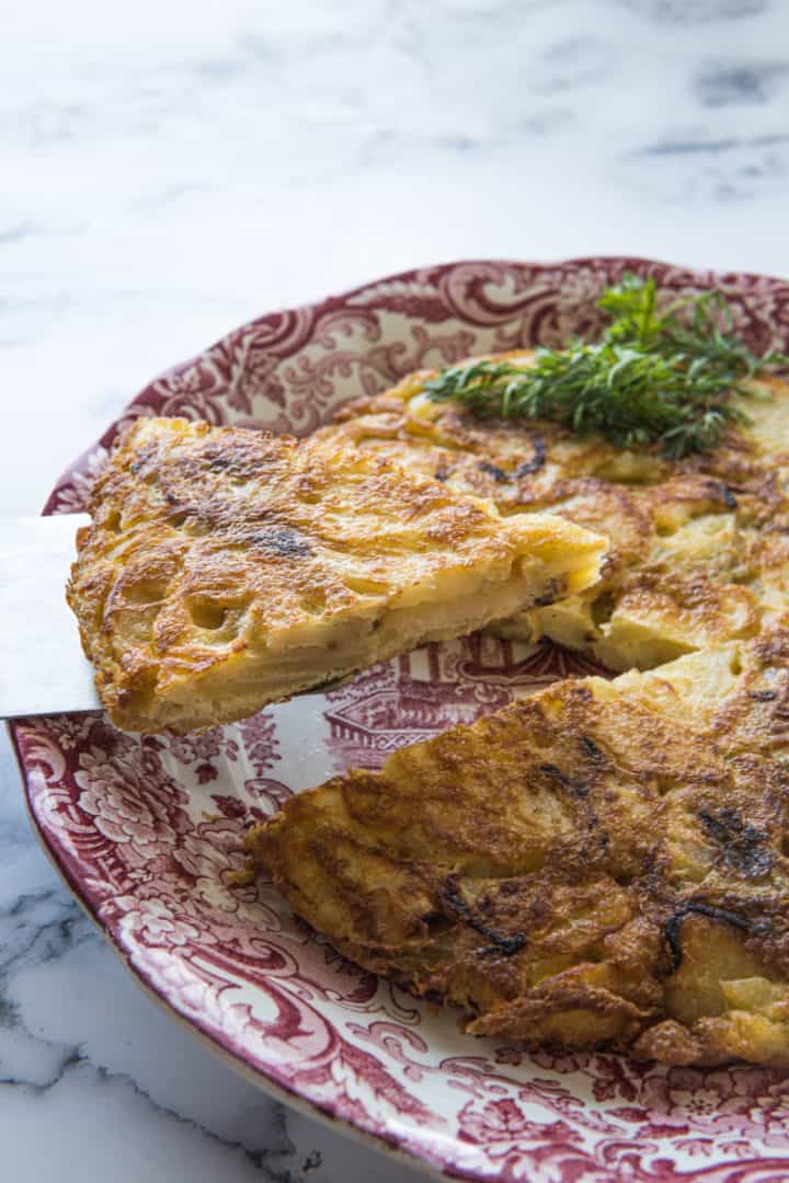 This is a Spanish Tortilla Recipe (Tortilla De Patatas) recipe made with gold potatoes, yellow onion, eggs, and lots of olive oil.