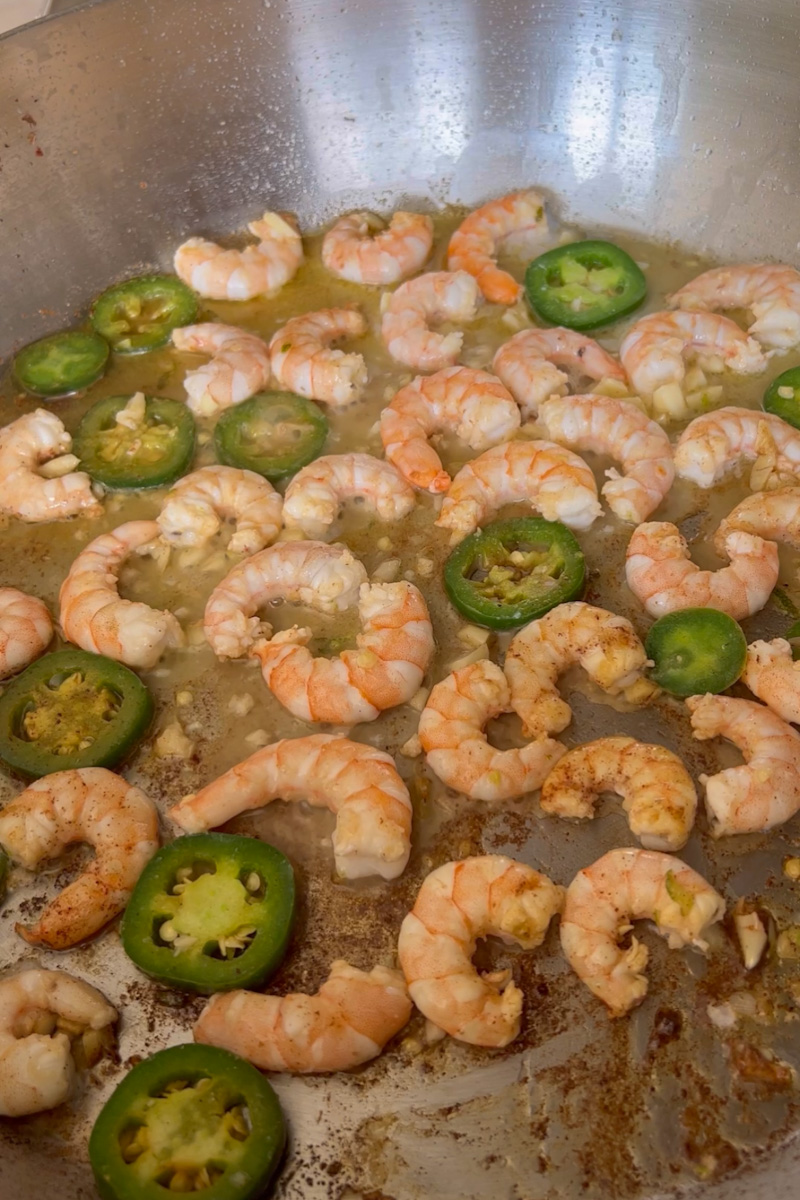 In a large pan, add butter and wait for it to melt. Add the shrimp without the marinade on the pan. Cook the shrimp 2 minutes on each side, until the shrimp turns pink and opaque. 