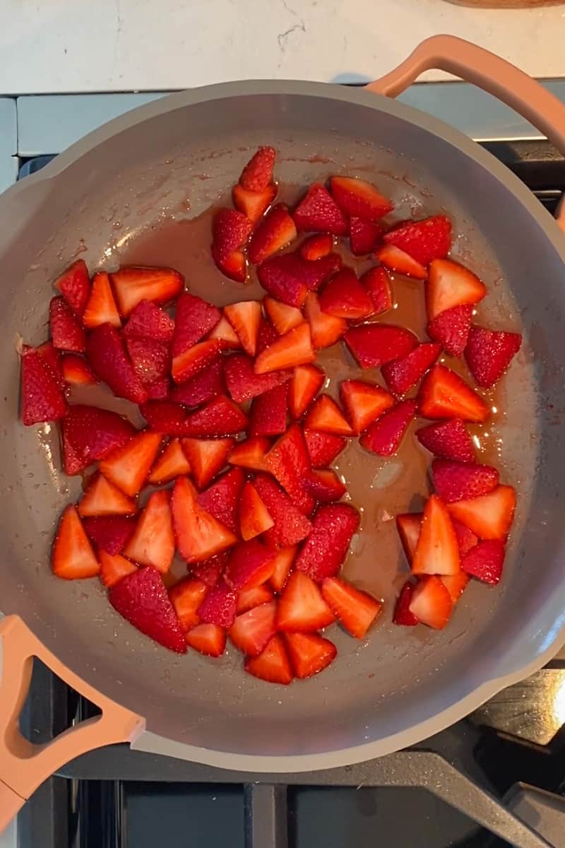 Make the strawberry sauce. In a medium saucepan on medium-low heat, add the strawberries, sugar and lemon juice. Wait until the strawberries heat up and begin to soften and eventually start to simmer, allowing the sugar to dissolve. Keep stirring for five minutes, or until a lot of the juices have come out.