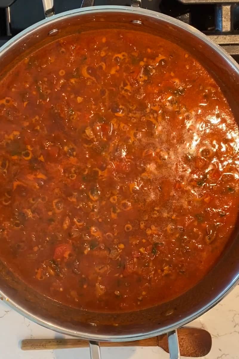 Cook and stir until the wine is almost all reduced, 4 to 5 minutes.Add the red wine vinegar and the canned tomatoes and season with salt and pepper. Reduce the heat to low and simmer, uncovered, for 8 to 10 minutes. Stir every once in a while.