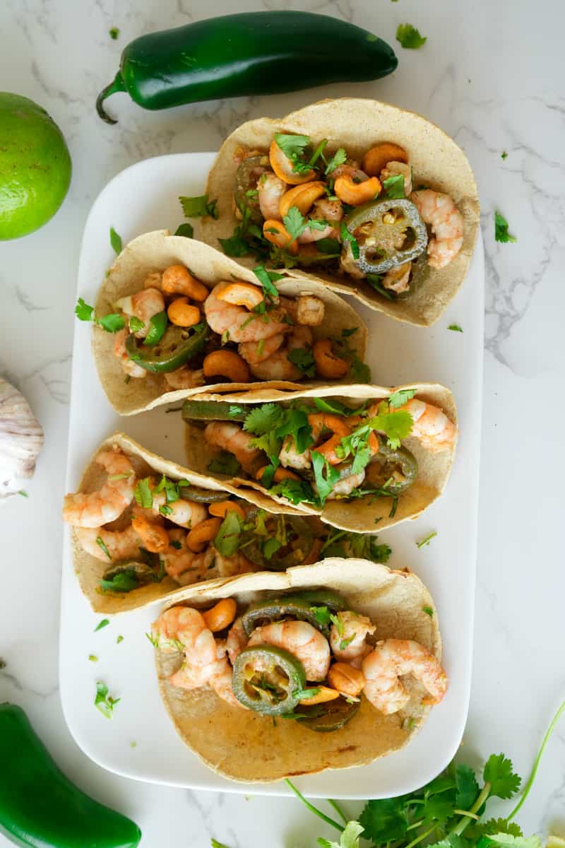 This Honey Lime Shrimp Tacos dish is made with shrimp, olive oil, garlic, jalapeños, limes, butter, and served on a warm tortilla.