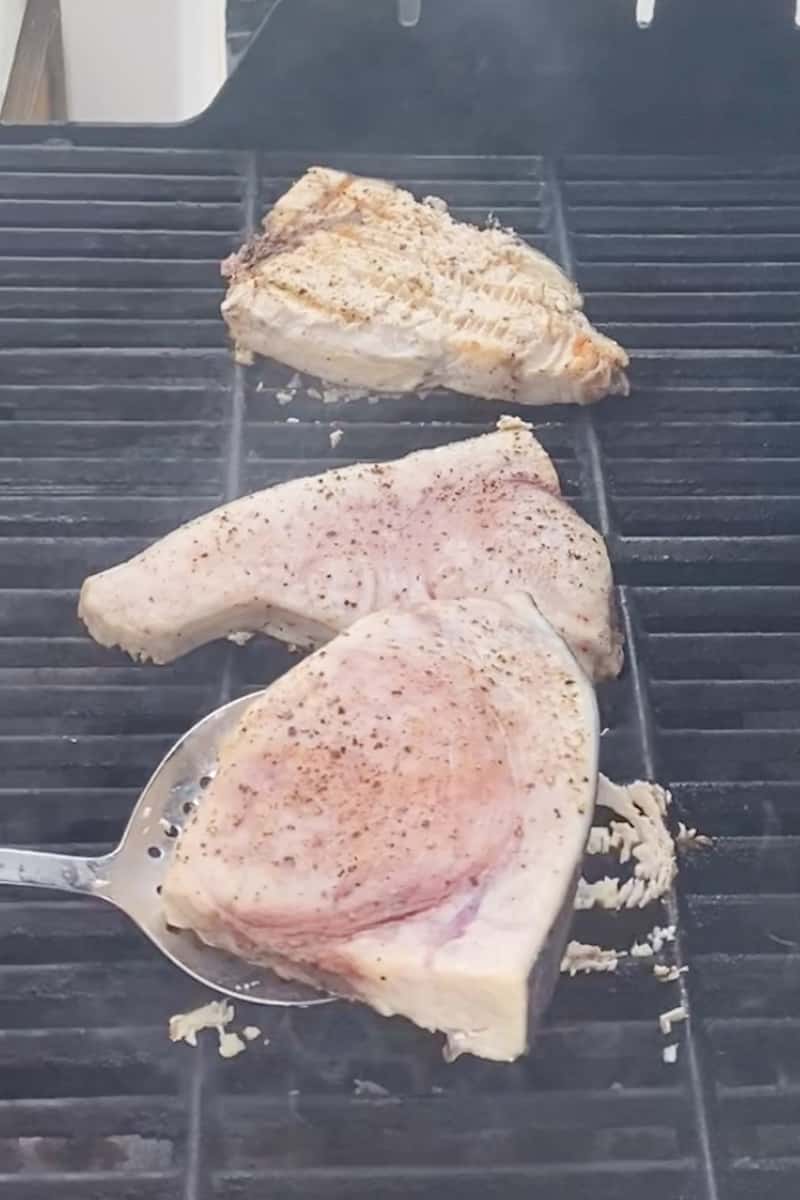 Place the swordfish on the grill. Cook for 5 minutes on one side then flip the sword fish. Apply the hot sauce on the cooked side with a brush. 