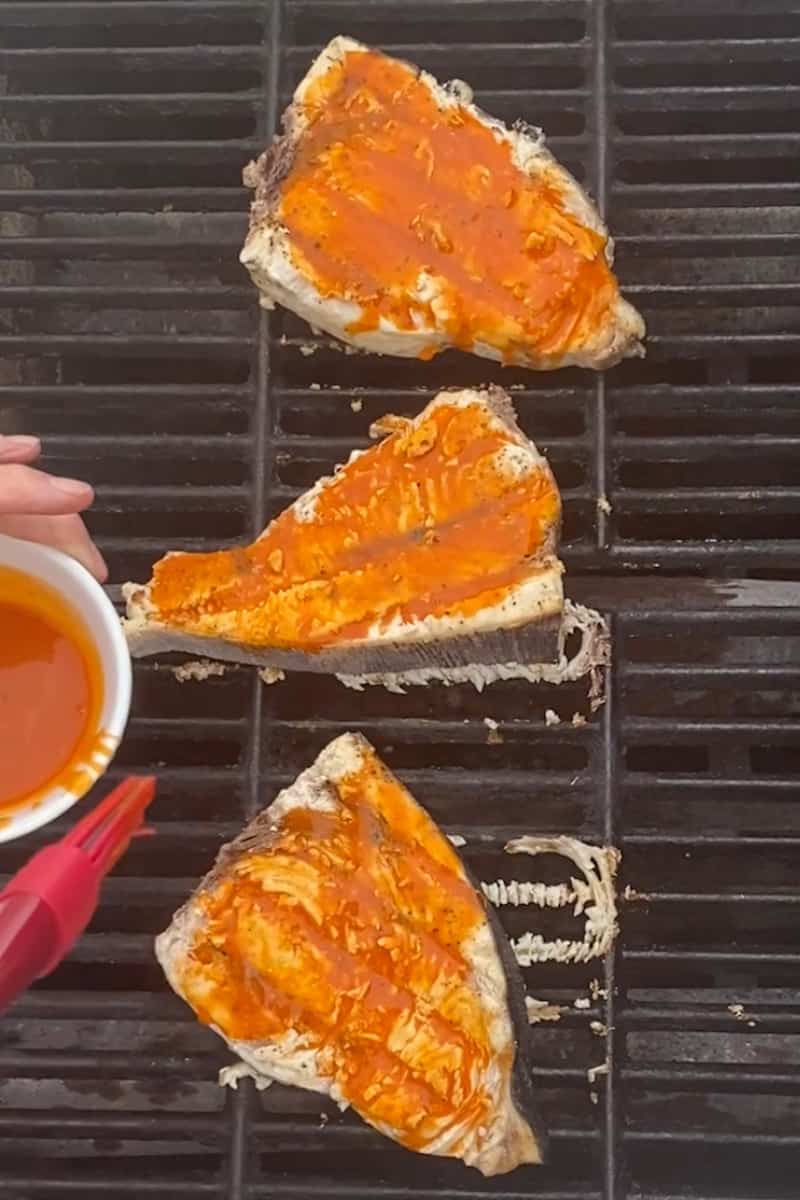 Cook for an extra 4 minutes, flip and apply hot sauce on the other side. The fish should flake easily while maintaining firmness.