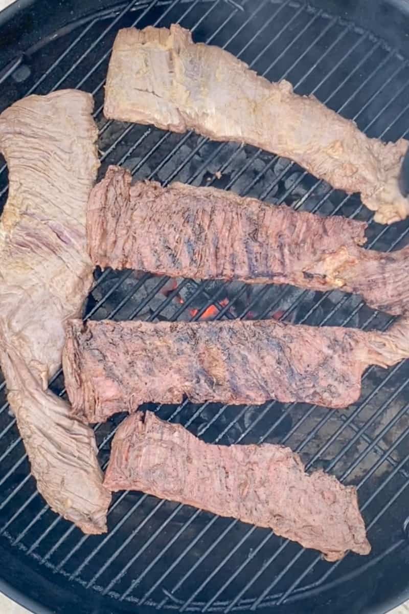 Place the seasoned skirt steak directly over the hot coals. Grill the steak for 3-4 minutes per side for medium-rare, or until the internal temperature of the steak reaches 135°F (57°C) on a meat thermometer.