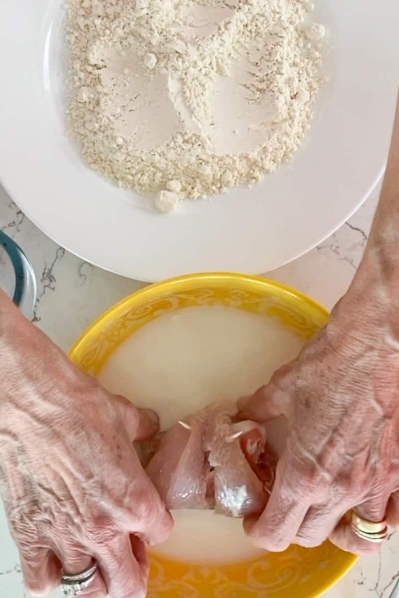 Dredge the chicken. In a large bowl, pour in the milk. In another large bowl, add the flour. Take each rolled up chicken and drench in the milk. Finish by dredging into the flour. Repeat with the rest.