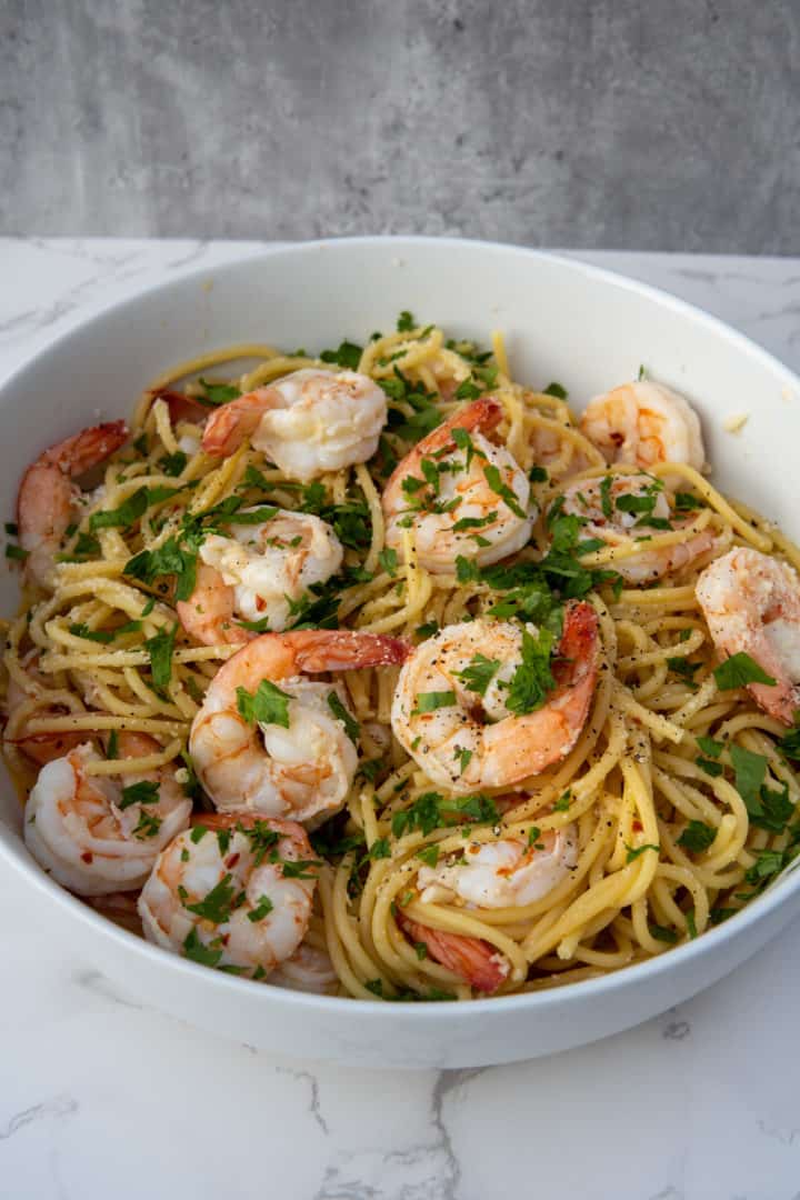 Use tongs to help flip the shrimp over. Combine the pasta and the shrimp, with the sauce, together. Finally, garnish with parmesan and parsley! Enjoy this Shrimp Scampi without Wine!