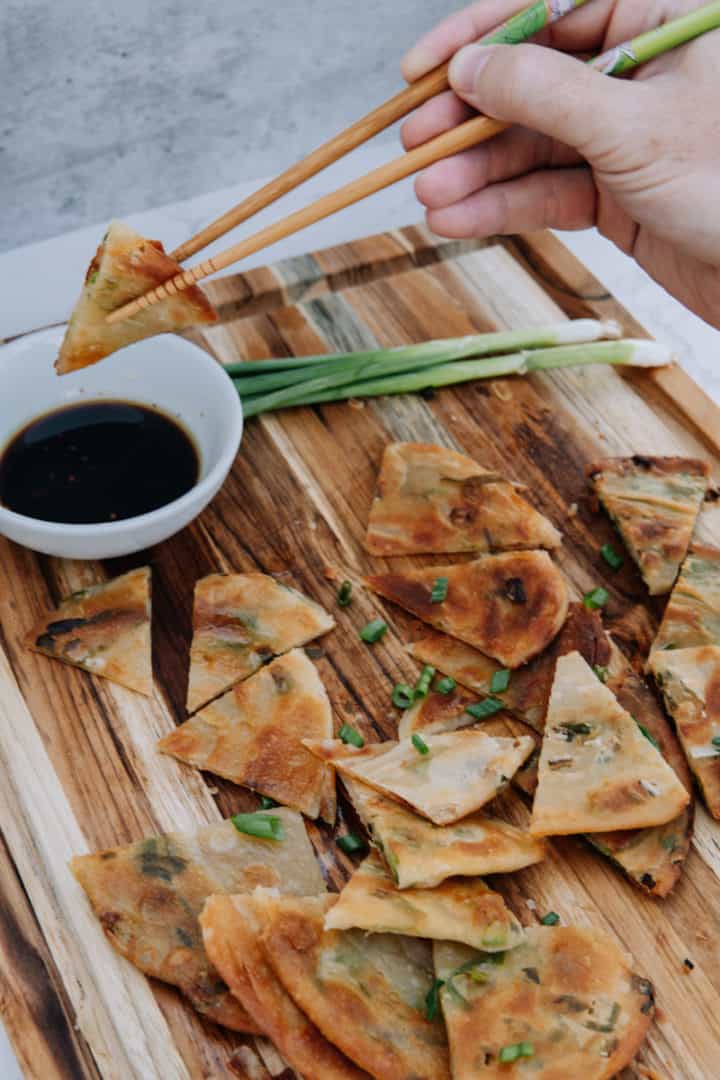 These Scallion Pancakes Recipe are made with flour, salt, scallions, vegetable oil, and dipped in a soy sauce, vinegar, and maple syrup.