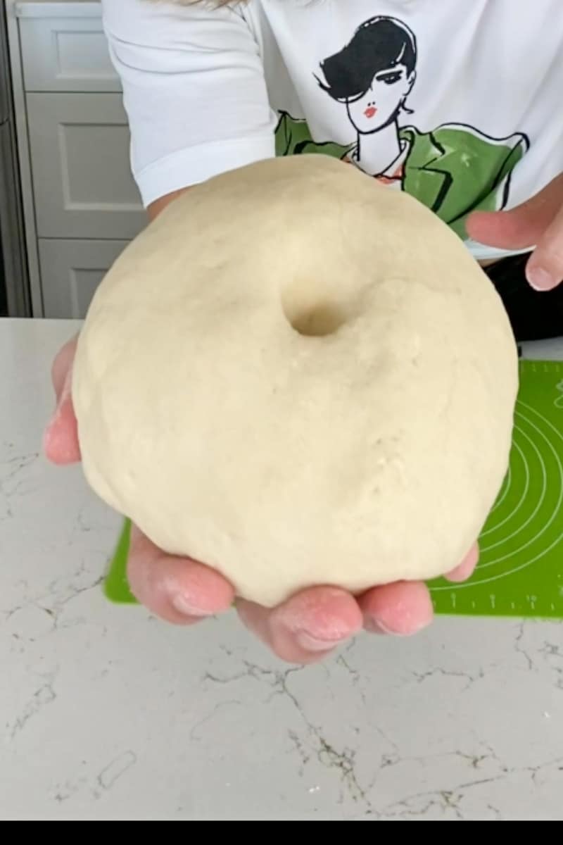 Make the dough. In a large bowl, add the flour and salt and whisk. Stir in a cup of boiling water and mix with a wooden spoon until a shaggy dough forms. Keep mixing and eventually start kneading the dough, adding flour until the dough isn’t sticky and is smooth. Cover and let it rest for an hour.