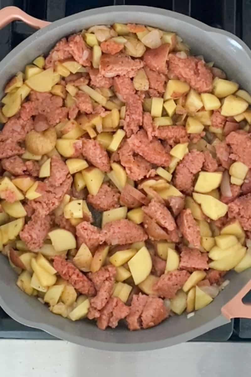 Add potatoes, cover, stirring occasionally to prevent sticking, for 10 minutes. Uncover, add salt and pepper, and cook for an extra ten minutes, stirring frequently. Turn off heat and sprinkle the mozzarella on the hash. Cover and let it sit for five minutes.