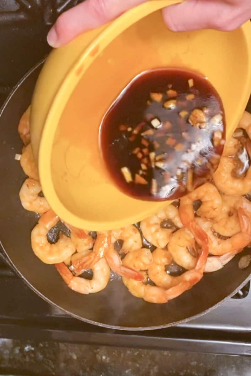 Try not to dump any of the juice in the pan. The shrimp should cook about 3 minutes on each side. Remember, you still have half of the fresh mixture left. Use tongs to flip each individual shrimp! After flipping the shrimp and three minutes have passed, pour the rest of the mixture in, stir, and remove.