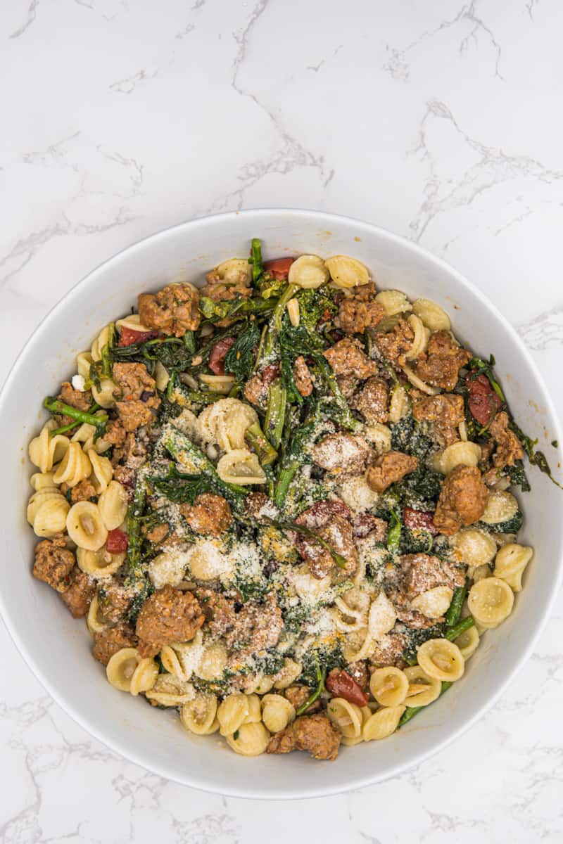 This Broccolini Sausage Pasta Recipe is made with sausage, broccoli rabe, garlic, diced tomato, and orecchiette pasta.