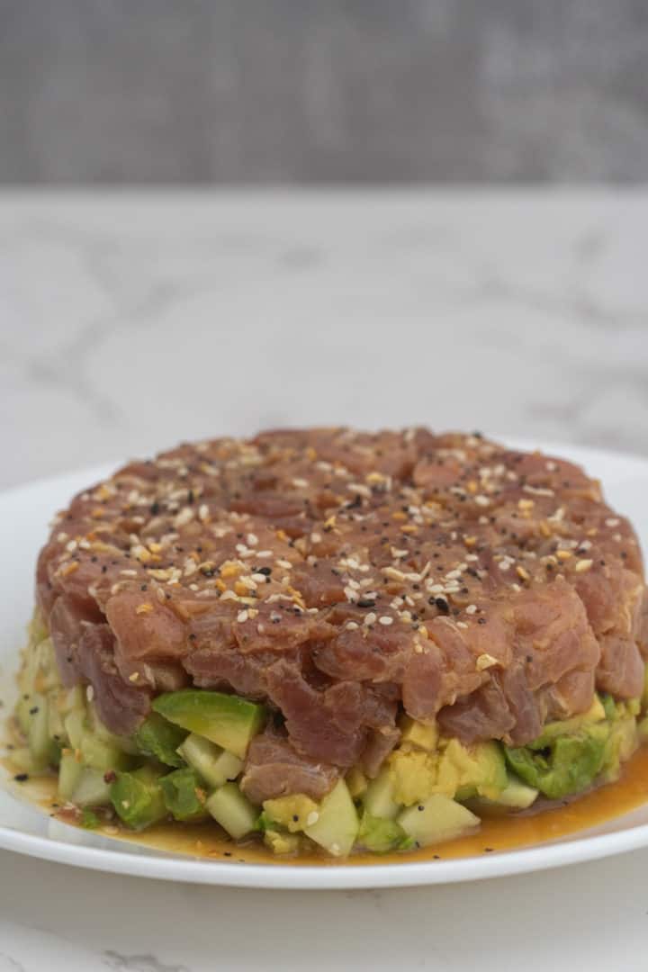This Tuna Tartare with Avocado is made with sushi-grade tuna, avocado, cucumber, soy sauce, sesame oil, honey and sesame seeds.