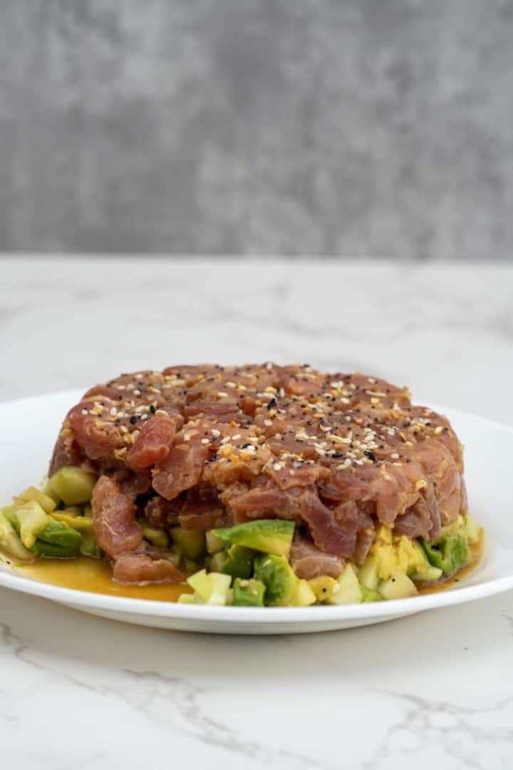 This Tuna Tartare with Avocado is made with sushi-grade tuna, avocado, cucumber, soy sauce, sesame oil, honey and sesame seeds.