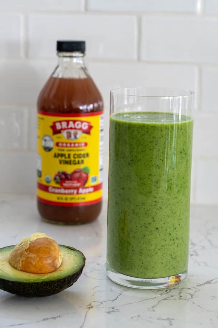 This Green Apple Smoothie is made with almond milk, apple cider vinegar, apples, bananas, kale, and blended into green perfection.