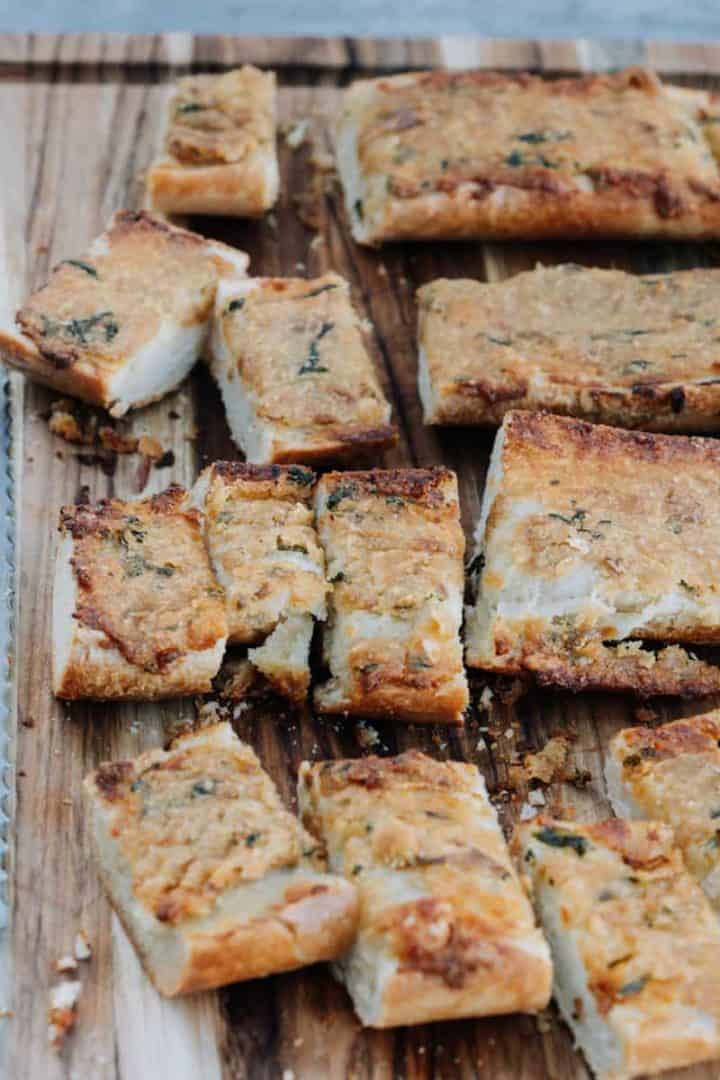 Dip into this Roasted Garlic Bread made with Italian Bread, garlic, butter, fresh basil, parmesan cheese, red pepper flakes and olive oil. 