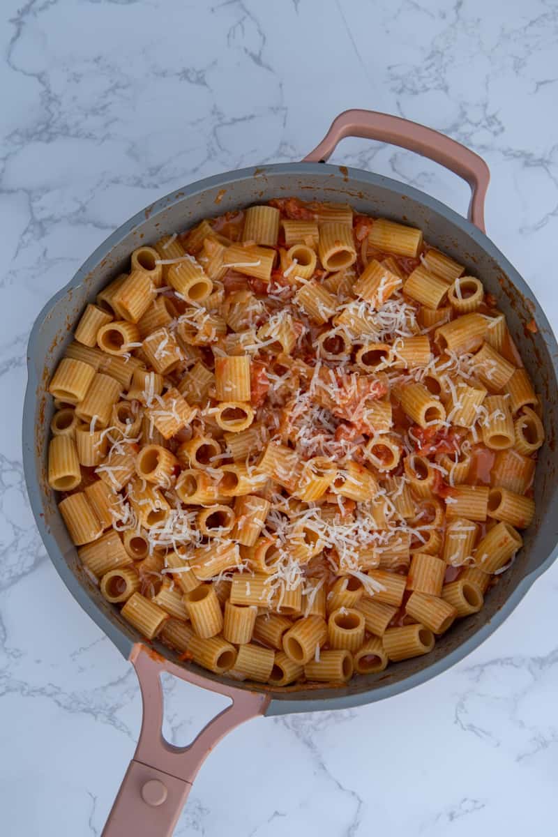This Carbone’s Spicy Rigatoni Recipe is made with rigatoni, butter, onions, tomatoes, Calabrian chilies, vodka, and heavy cream.