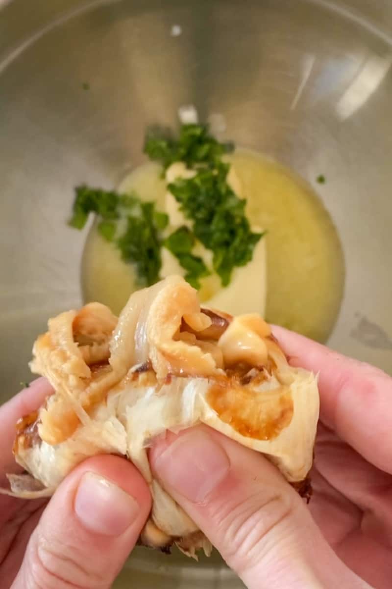 In a bowl, add the butter, basil, parmesan cheese, red pepper flakes and a pinch of salt. Squeeze the garlic into the bowl using your hands or a spoon.