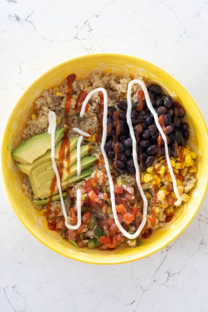 This Quinoa Power bowl is made with quinoa, corn, black beans, pico de gallo, avocado, and a delicious spicy mayonnaise.