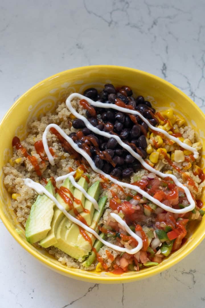 In a separate small bowl, add mayonnaise, sriracha and sesame oil and mix. Pour the mixture into the quinoa bowl and mix. Top with beans, pico de gallo, and avocado.