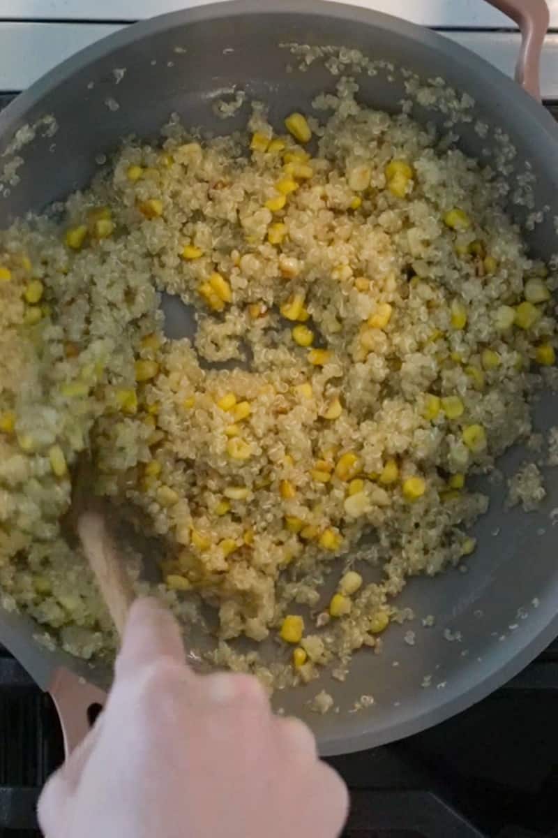 Once the quinoa is cooked through, toss in the corn. Add the quinoa mixture in a bowl.