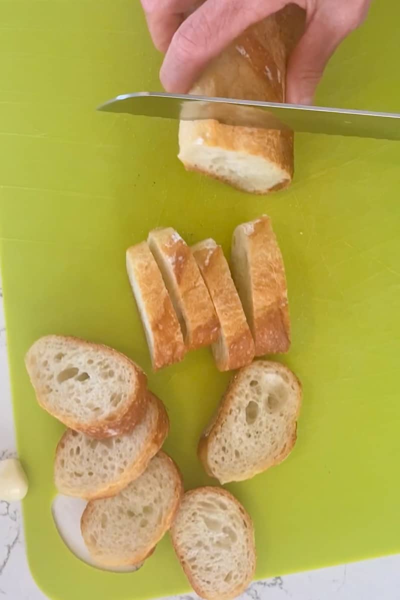 Preheat the grill to medium-high heat or oven to 450°F. Start by slicing the Italian bread. Pour olive oil into a small bowl and with a brush gently brush the olive oil onto each sliced piece of bread.