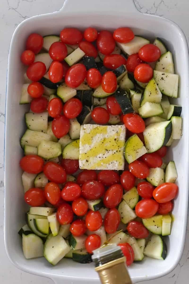 Drizzle olive oil and sprinkle salt, pepper and oregano. Bake in the oven for 45-55 minutes, until the cherry tomatoes are bursting and the zucchini is golden.