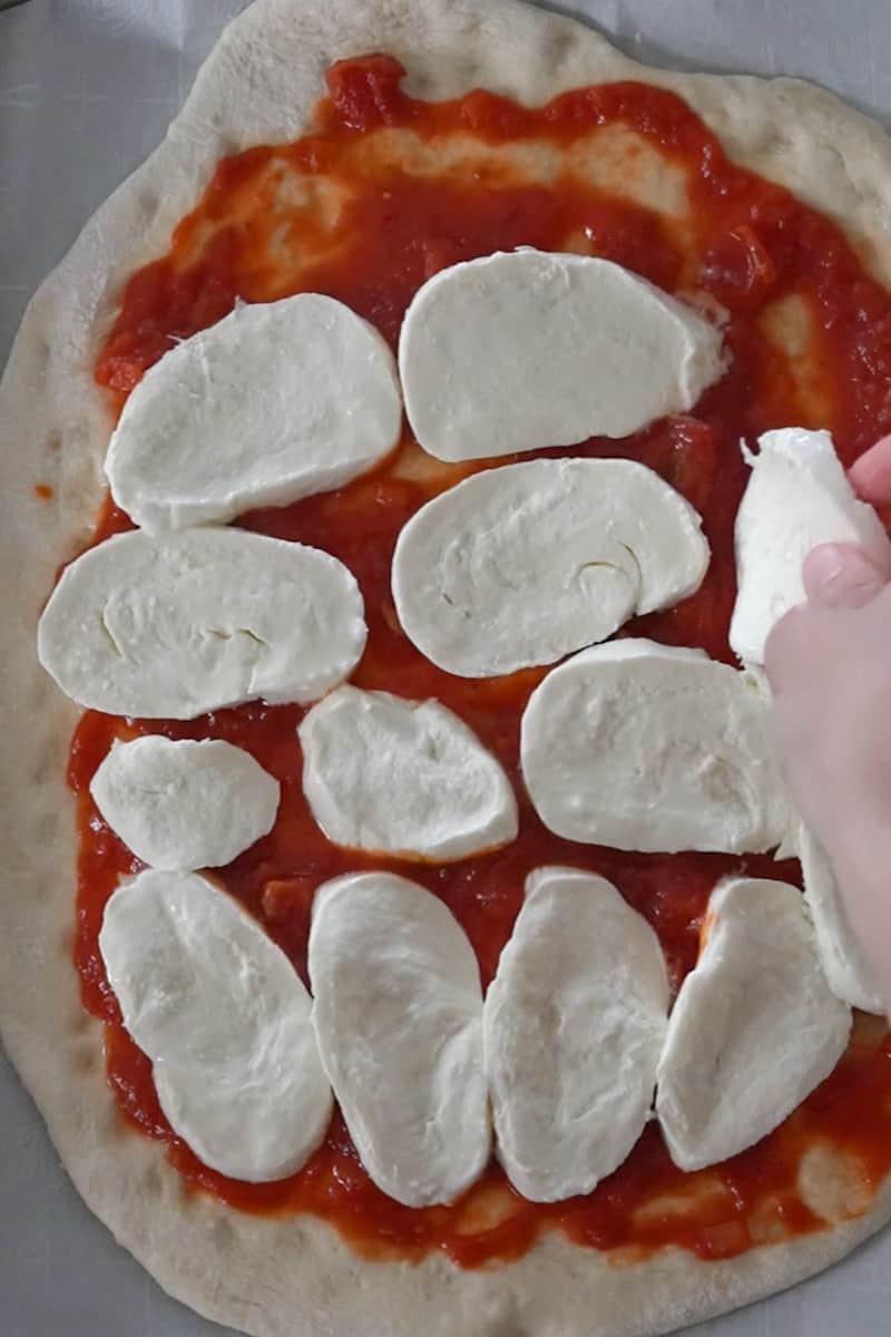 Slice the mozzarella and add about 5 slices or more if needed. Cut the cherry tomatoes in half and add as well. 